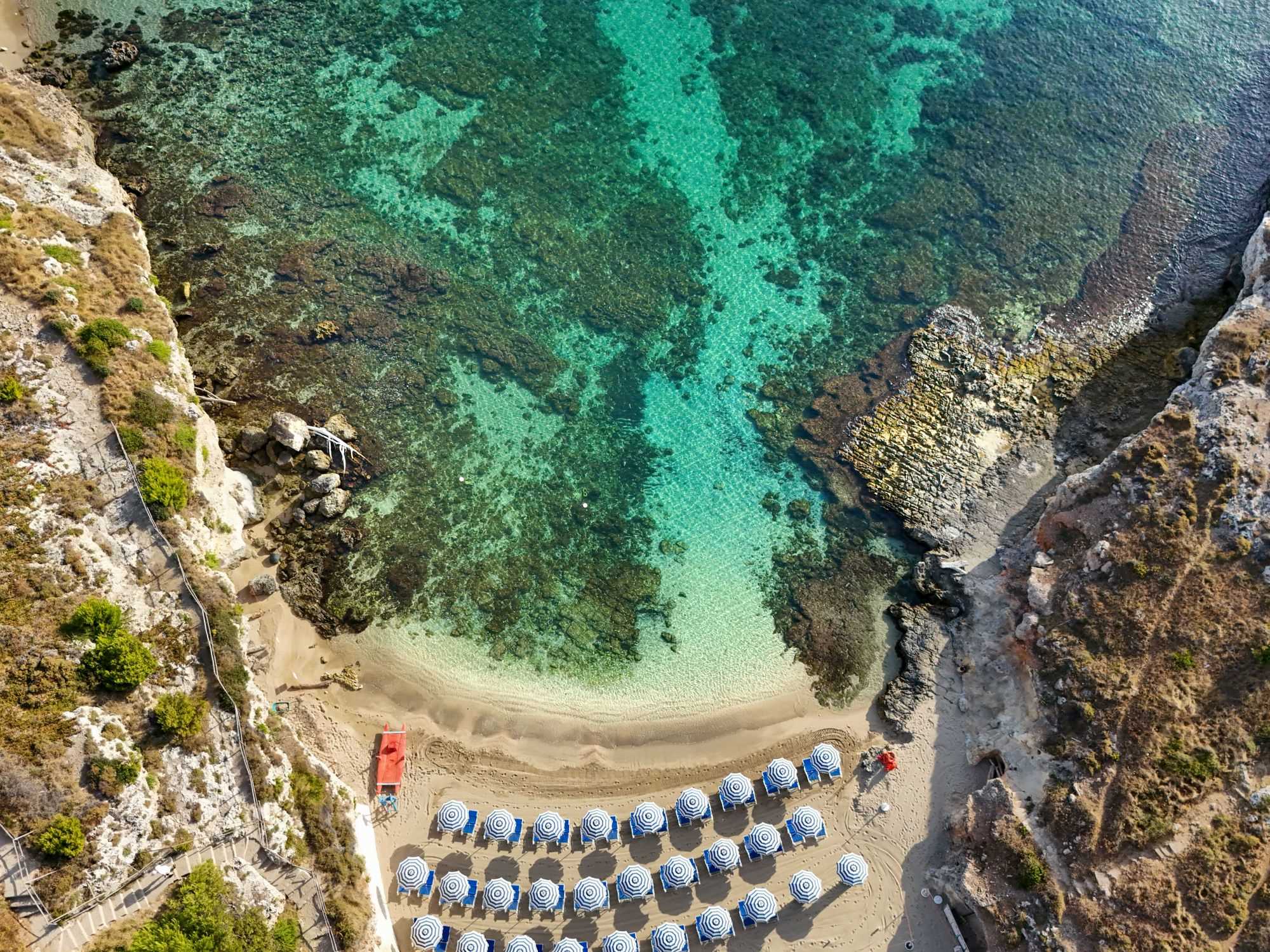 Caletta di Cala Corvino vista dall’alto con acqua cristallina e fondale sabbioso a Monopoli